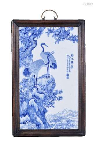 A large Chinese blue and white porcelain plaque, signed Wang Bu, depicting two cranes perched on a