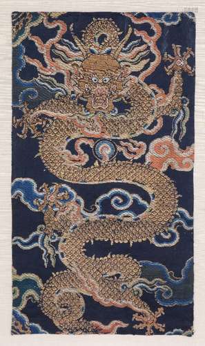 A Chinese brocade fragment of a large coiling five clawed dragon, Qing Dynasty, Kangxi period, early