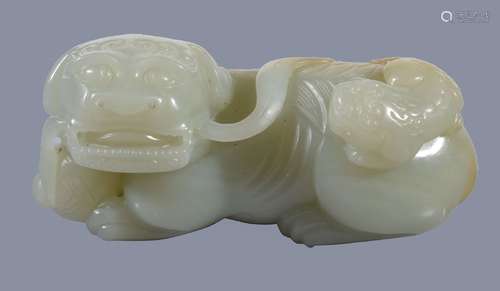 A Chinese celadon and russet jade 'lion and cub' carving, Qing Dynasty, the recumbent Buddhist