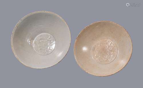 Two Qingbai glazed bowls, Southern Song-Yuan Dynasty, each moulded to the centres with twin fish,