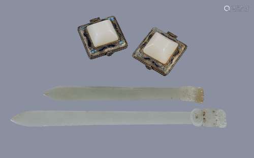 Two Chinese pale celadon jade hair pins, each of thin, curving section and spatulate form surmounted