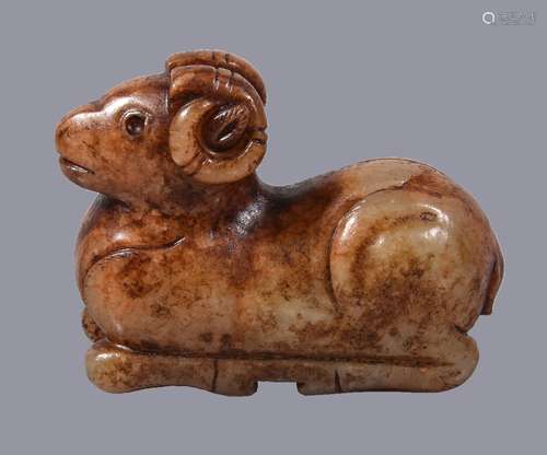 A Chinese celadon and russet jade figure of a ram, recumbent, with head looking forwards and its