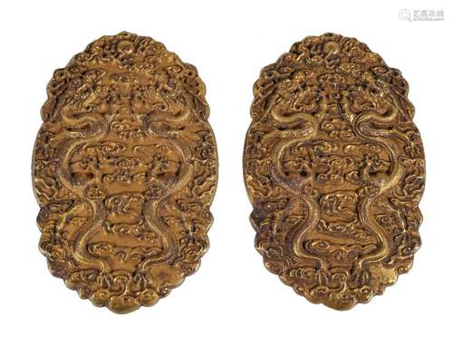 A Chinese gilt bronze 'Dragon' tally, cast in relief on a textured ground with dragons disputing a