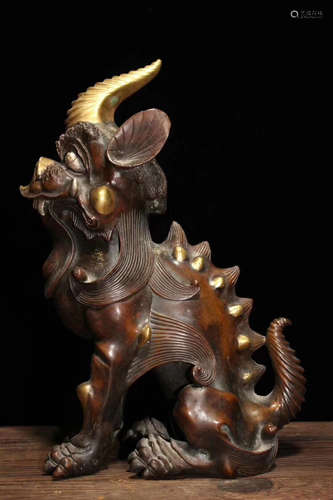 A GLIT-BRONZE UNICORN FIGURE