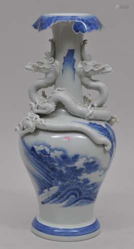 Porcelain vase. Japan. 19th century. Hirado ware. Pair of moulded dragons at the shoulder. Foliated edge. Underglaze blue decoration of a landscape. 14-1/4