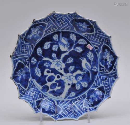 Porcelain plate. China. 18th century. Underglaze blue decoration of birds and flowers. Foliated edge. Cheng Hua mark. Rim frits. 8-3/4