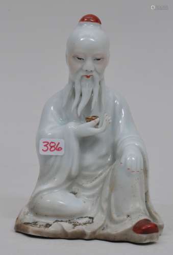 Porcelain figure. China. Early 20th century. Old man seated holding a wine cup. Signed with a seal on the base. 4