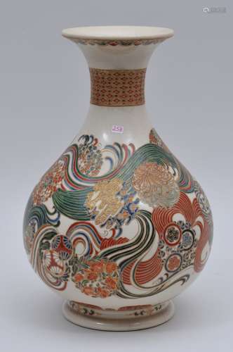 Pottery vase. Japan. 19th century. Satsuma ware. Pear shaped with a flaring mouth. Decoration of swirling brocades. Signed. 13