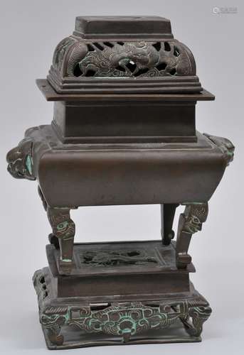 Bronze censer and stand. China. 19th century. Rectangular form. Repousse decoration of dragons and foo dogs. Ming Hsuan Te mark on the base. 11