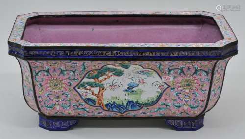 Canton enamel planter. China. 19th century. Rectangular form with cut corners. Famille rose enamel decoration of floral scrolling and reserves of mandarin ducks and longevity emblems. 10-1/2
