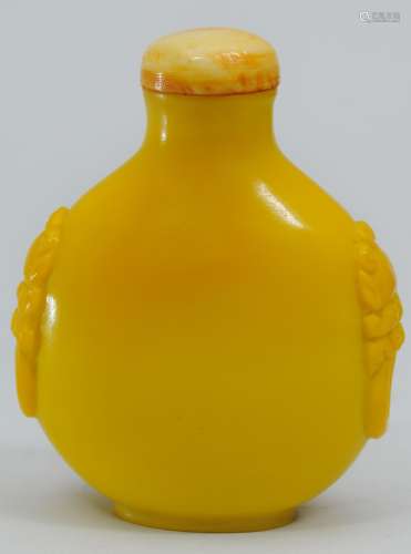 Snuff bottle. China. 19th century. Yellow glass with faux foo dog jump rings. 2-1/2