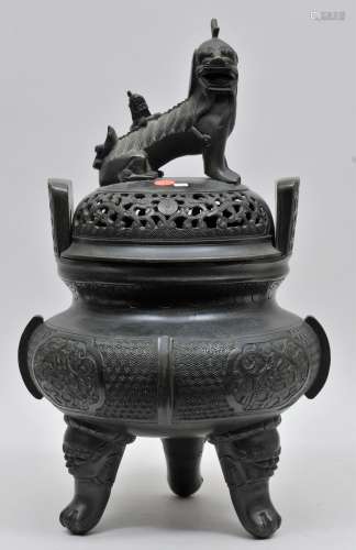 Bronze incense burner. China. 19th century. Animal form feet. Foo dog finial. Floral reserves on a draped ground. 20