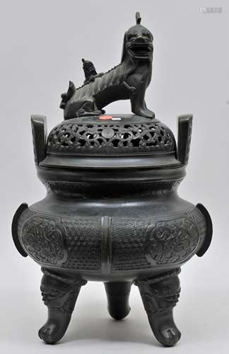 Bronze incense burner. China. 19th century. Animal form feet. Foo dog finial. Floral reserves on a draped ground. 20