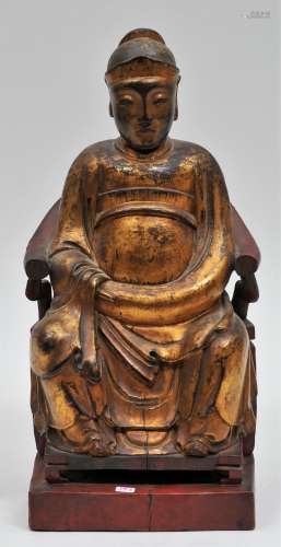Carved wooden household Deity. China. 19th  century. Enthroned figure. Surface of gold and red lacquer. 13
