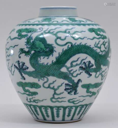Porcelain jar. China. Late 19th century. Oviform. Decoration of green enameled dragons, clouds and the 