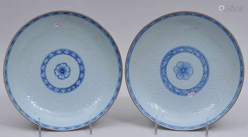 Pair of porcelain bowls. China. 18th century. Carved floral decoration with underglaze blue brocade patterns borders. 8-1/2