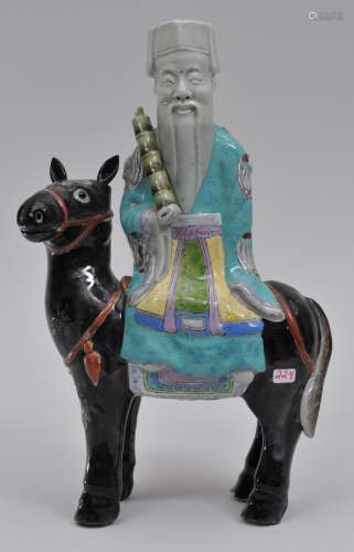 Porcelain figure. China. 19th century. Export ware figure of an immortal riding a black horse. 11