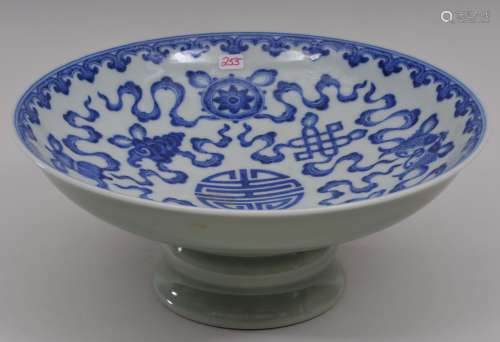 Porcelain tazza. China. 20th century. Interior with underglaze blue decoration of teh eight precious emblems. Exterior celadon. 8-1/2