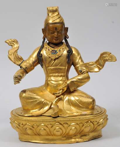 Repousse gilt copper image. Tibet. 19th century. Seated figure of Padmasakava. Turquoise inlays. Break to one ribbon. 14