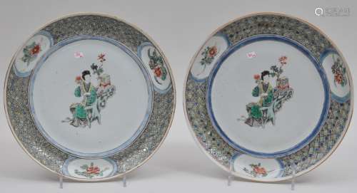 Pair of porcelain plates. China. 19th century. Famille verte decoration of women with borders of diapre patterns and floral reserves. 10