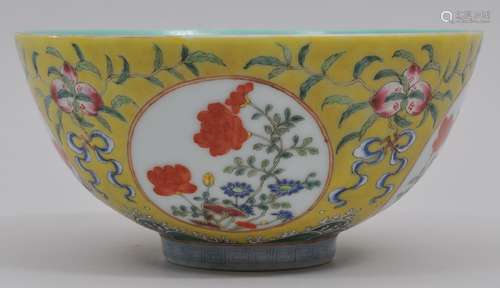 Porcelain bowl. China. 19th century. Floral reserves on a yellow ground with peaches in Famille rose enamels. 5-7/8