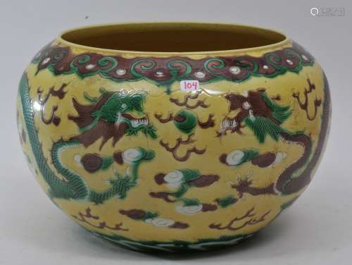 Porcelain bowl. China. Late 19th century. San Tsai decoration of dragons, pearls and clouds. Ju-i borders. Aubergine, green and white on a yellow ground. 10