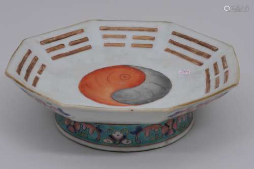 Porcelain footed dish. China. 19th century. Octagonal shape. Famille Rose decoration of the Yin Yang and the Trigrams with floral scrolling. Tung Chih mark on the base. 9