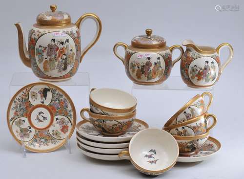 Pottery tea set. Japan. Meiji period (1868-1912). Satsuma ware. Tea pot,  creamer and sugar with six cups and saucers. Signed.