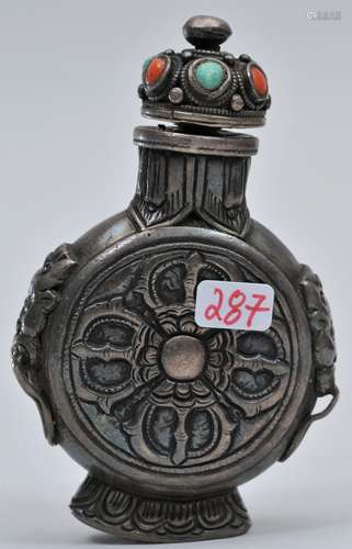 Snuff bottle. Sino-Tibetan. 19th century. Repousse silver with a design of dragons and double vajra top. Inset with coral and turquoise. 2-3/4