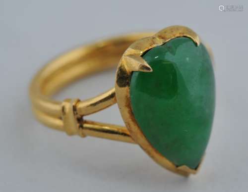 Good Emerald green Jadeite heart shaped Cabuchon mounted as a ring in high carat gold.