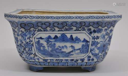 Porcelain planter. China. 19th century. Rectangular hexagonal form. Underglaze blue decoration of landscape reserves on a flower and butterfly ground. 9-1/2