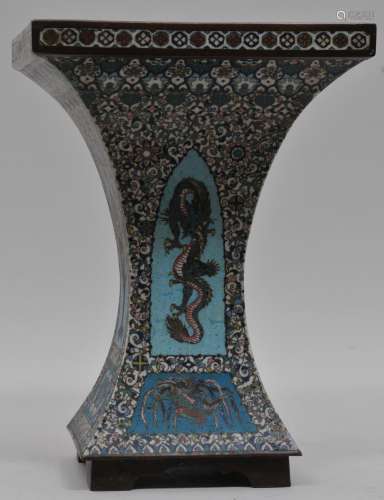 Cloisonne vase. Japan. Meiji period (1868-1912). Squared hourglass shape. Decoration of drum stands and dragons on a floral ground. 13