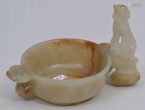 Jade wine cup. China. 19th century. Highly translucent yellow grey stone with russet markings, Ju-i handles. Body carved with flowers. 5
