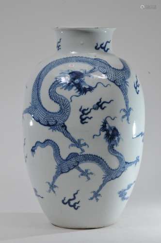 Porcelain vase. China. 19th century. Oviform shape. Underglaze blue decoration of dragons, flowers, pearls and clouds. K'ang Hsi mark. Hairlines and chips. 18
