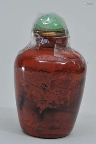 Snuff bottle. China. 19th century. Realgar coloured glass. Jade stopper. 2-1/4