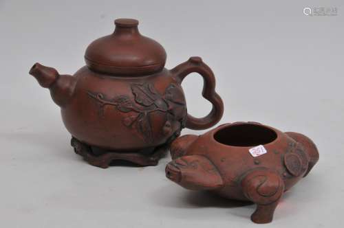 Two Yi Houng pots. China. Early 20th century. One teapot shaped like a double gourd with foliage: the other shaped as Liu Hai's frog with cash coins. Both signed. 5