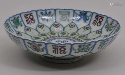 Porcelain bowl. China. 20th century. Moulded in the form of an open lotus. Tou Tsai decoration of sanscrit characters and 