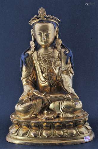 Gilt bronze. Tibet. 16th century. Jeweled seated figure on a double lotus throne. 9