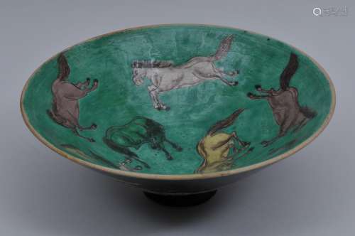 Porcelain bowl. China. 20th century. Conical form. Famille Verte decoration of a historical scene on the exterior. Eight horses on the interior. 10