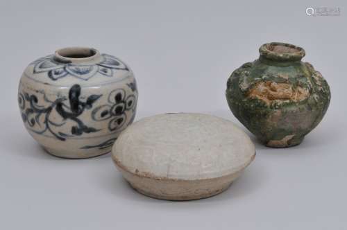 Lot of three ceramics. China. Ming period and earlier. To include: A small jar with underglaze blue floral decoration, a ying ching covered box and a green glazed jar decorated with a relief dragon. Each about 3
