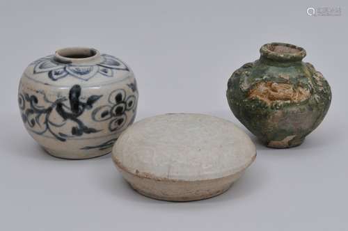 Lot of three ceramics. China. Ming period and earlier. To include: A small jar with underglaze blue floral decoration, a ying ching covered box and a green glazed jar decorated with a relief dragon. Each about 3