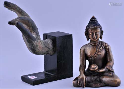Two Buddhist bronzes. South East Asia. To include: A hand and a figure of Amida Buddha. Each about 3-1/2