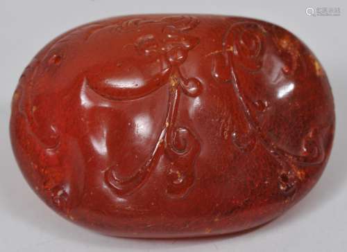 Hat button. China. 18th/19th century. Amber carved with a fish and aquatic plants. 2-1/4