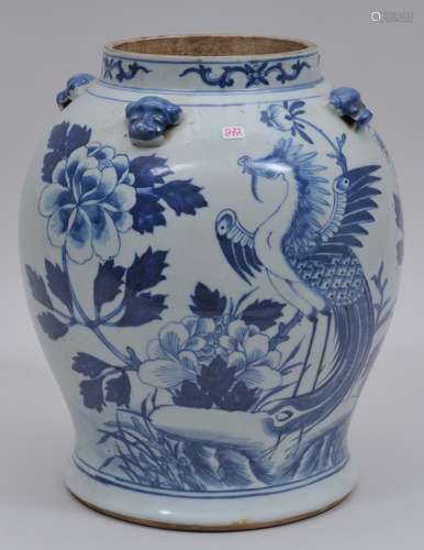 Porcelain jar. China. 19th century. Baluster form. Underglaze blue decoration of phoenixes and peonies. Four foo dog lugs. Hairline to the base. 11