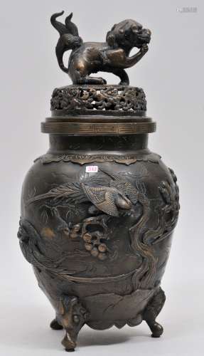 Bronze censer. Japan. Meiji period (1868-1912). Vase form with a tripod base. Foo dog finial. Decoration of birds and flowers. 14-1/2