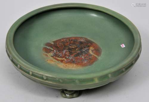 Celadon Narcissus bowl. China. Yuan period (1279-1368). Tripod base. Interior carved with flowers. Burned red where there is no glaze cover. 12