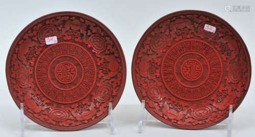 Pair of Cinnebar saucer dishes. China. 18th/19th century. Surfaces carved with bats, flowers and stylized shou characters. 5