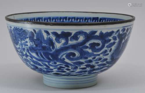 Porcelain bowl. China. Ming period (1368-1644). Underglaze blue decoration of foliated dragons and phoenixes on a floral ground. Hsuan Te six character mark. Copper rim (crack). 8
