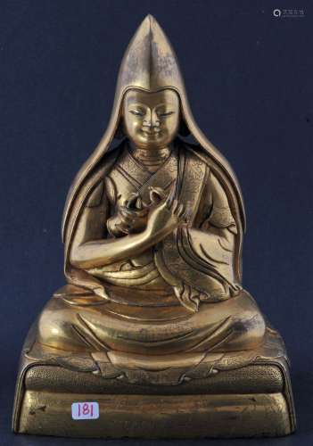 Gilt bronze figure of a high Lama. Seated figure holding a vajra and a bell. Engraved details. 8