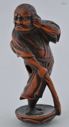 Wooden Netsuke. Japan. 19th century. Standing figure holding a walking stick. 2-1/2